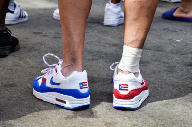A Marcher Wears Festive Shoes with the Puerto Rican Flag Embroidered on the Back