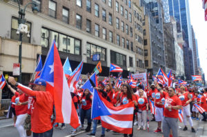 The Parade Begins and the Marchers Wave their Flags